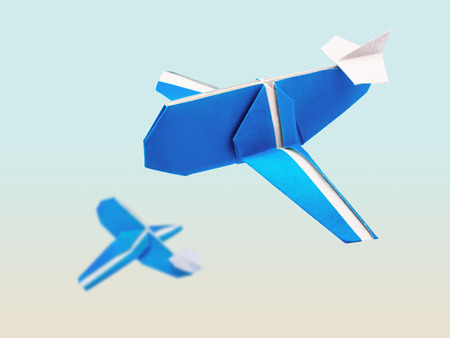 Origami blue cartoon paper travel isolated airplanes in 
airport on blue backgroundの写真素材