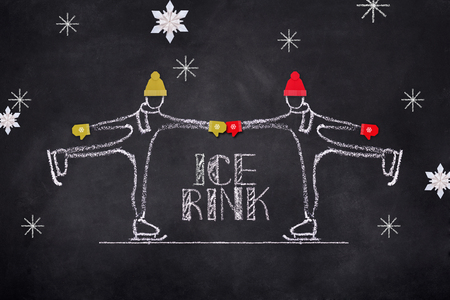Chelk sketch of pair skating on ice rink, Hand drawn illustration on black boardの写真素材