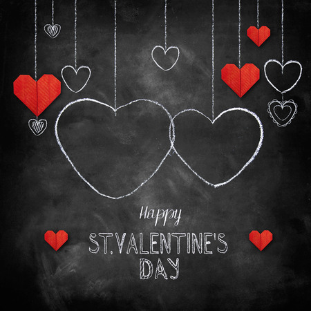 Hand drawn chalk lettering - Valentine's Day with origami paper hearts - on chalkboard. Hand painted text.の写真素材