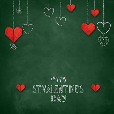 Hand drawn chalk lettering - Valentine's Day with origami paper hearts - on chalkboard. Hand painted text.の写真素材