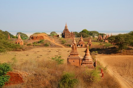 Several ancient temples on a field in Bagan, Myanmarの写真素材