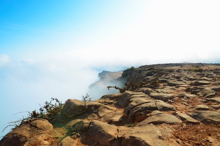 View from the top of a mountain over the clouds in Omanの写真素材