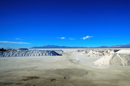 Long shot of the Salinas Grandes salt flats in North Argentina at the foot of the Sierras de Cordoba mountain range in South Americaの写真素材