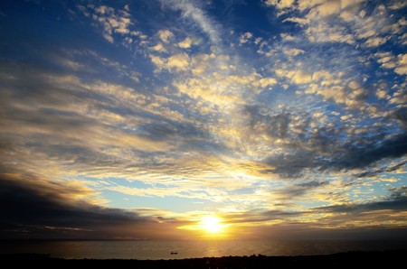 Long shot of the sunset at Puna Pau an extinct volcano where the pukaos, or moai headdresses, were built in Easter Island, Rapa Nui, Chile, South Americaの写真素材