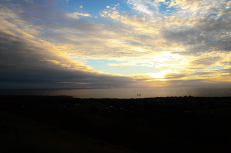 Long shot of the sunset at Puna Pau an extinct volcano where the pukaos, or moai headdresses, were built in Easter Island, Rapa Nui, Chile, South Americaの写真素材