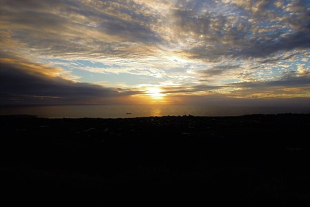 Long shot of the sunset at Puna Pau an extinct volcano where the pukaos, or moai headdresses, were built in Easter Island, Rapa Nui, Chile, South Americaの写真素材