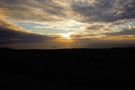 Long shot of the sunset at Puna Pau an extinct volcano where the pukaos, or moai headdresses, were built in Easter Island, Rapa Nui, Chile, South Americaの写真素材
