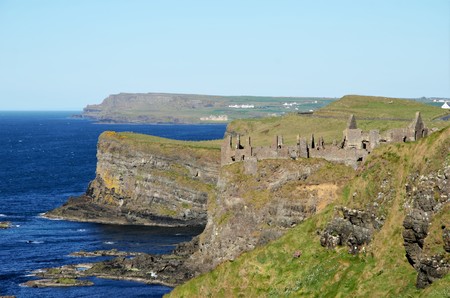 Long shot of the ruins of Dunluce Castle in the County Antrim in Northern Ireland, UKの写真素材