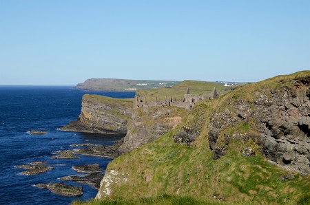 Long shot of the ruins of Dunluce Castle in the County Antrim in Northern Ireland, UKの写真素材
