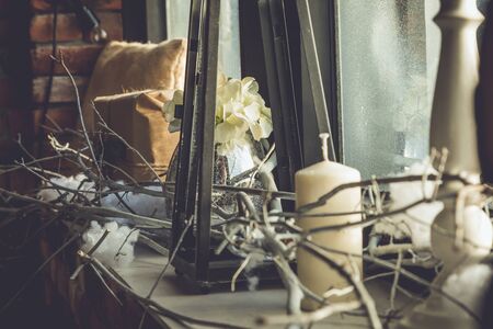 candle decoration with flower vase and gifts on a tableの写真素材
