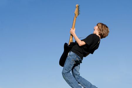 Happy child singing and playing guitarの写真素材