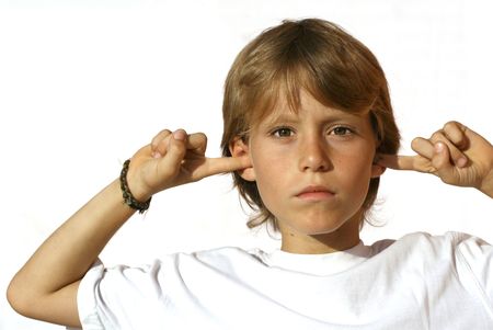 defiant child with fingers in earsの写真素材