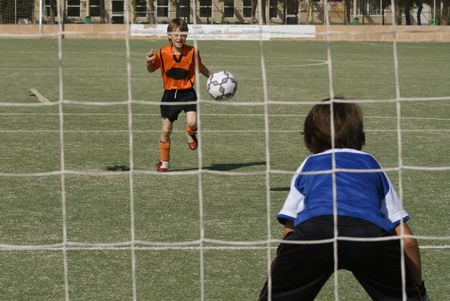 young boys playing footballの写真素材