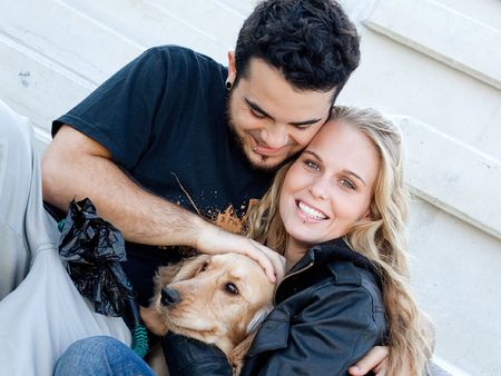 happy couple with pet dogの写真素材