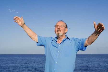 happy senior man arms raised with joy and happinessの写真素材