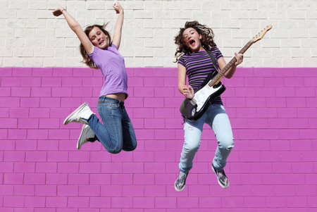 teens jumping playing guitar