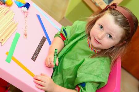 happy smiling kid drawing at home or school kindergarden or kindergartenの写真素材