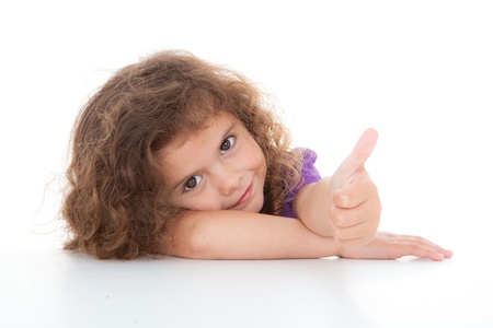 happy positive child with thumbs up for successの写真素材