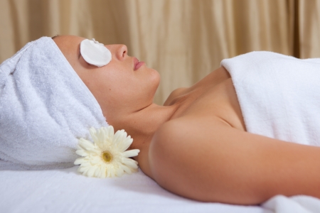 woman relaxing with eyepads on eyes at spaの写真素材