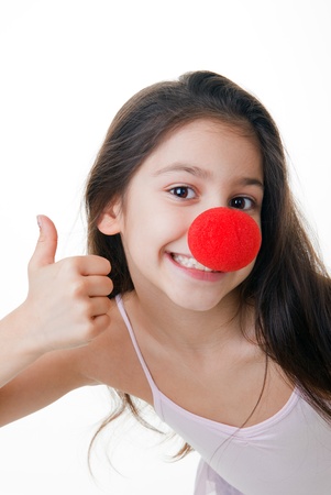child with red clown nose thumbs upの写真素材