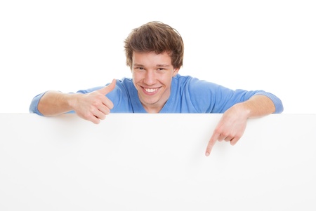 happy smiling, young man with thumb up pointing at copy space.の写真素材