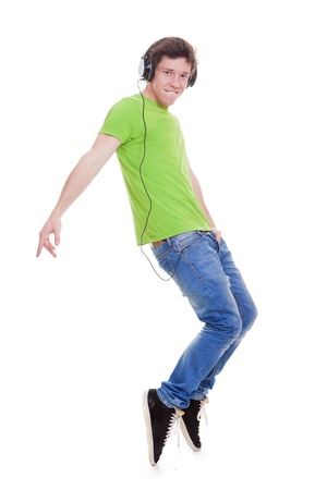teen boy with headphones dancing to musicの写真素材