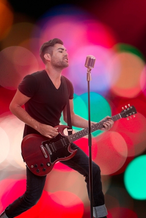 male performer singing live performance with guitarの写真素材
