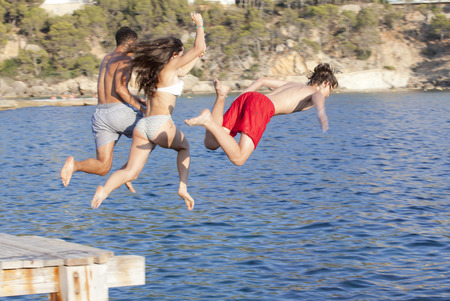 kidsor teens jumping in sea or oceanの写真素材