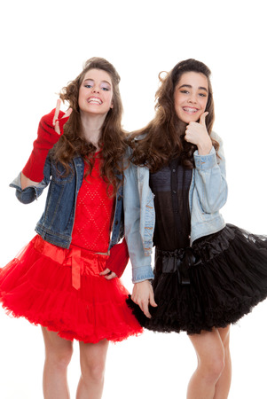 positive fashion teens thumbs up and victory sign dressed to partyの写真素材