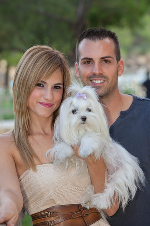 young couple with pet maltese dogの写真素材
