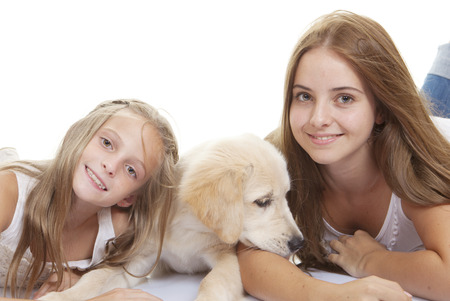 family pets pup with smiling girlsの写真素材