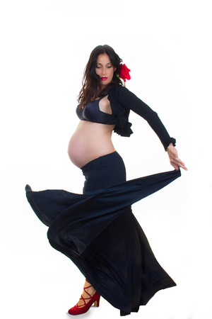 active pregnant woman doing spanish dancingの写真素材