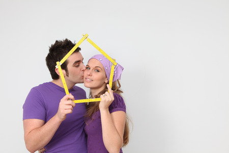 kissing couple getting mortgage loan for new house conceptの写真素材