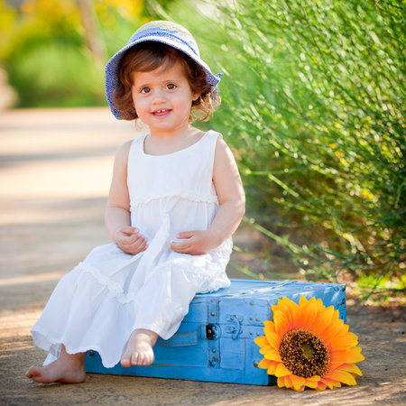 happy child sitting outdoors in summerの写真素材