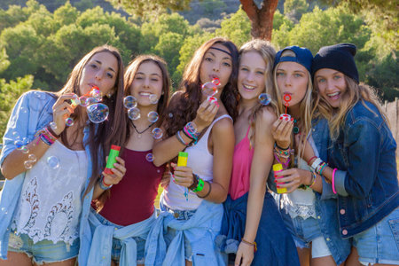 group of teens blowing bubbles