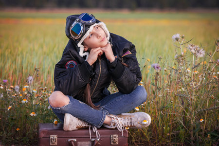 child dreaming of travel vacation or holidays with suitcaseの写真素材