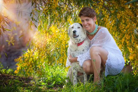 family pet mongrel dog outdoors with female owner