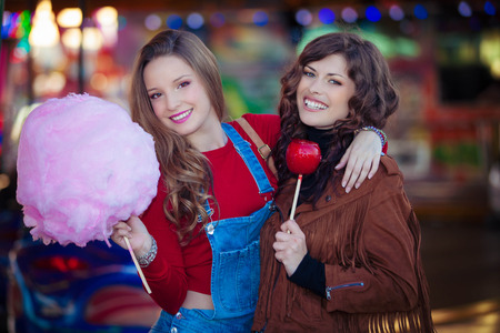 teens at fair with candyの写真素材
