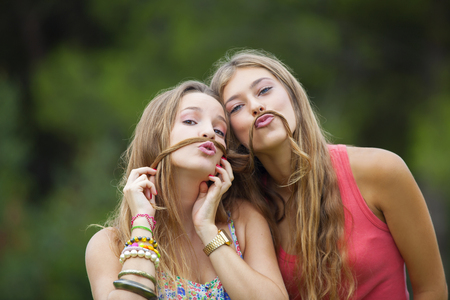 healthy young teens girls goofing about.の写真素材