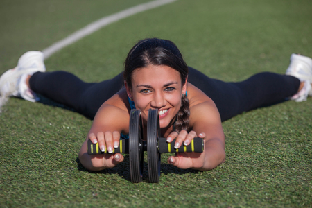 fitness female athlete exercising with toning wheelの写真素材