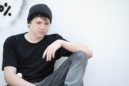 sad depressed lonely adolescent teen boyの写真素材
