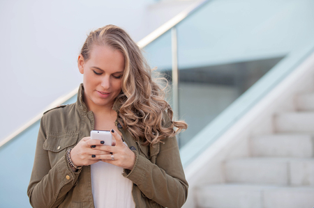 woman or teen texting on cell or mobile phoneの写真素材