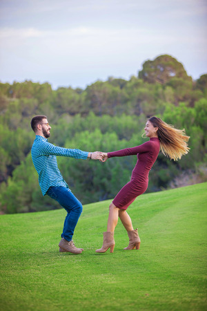happy playful young couple in love outdoorsの写真素材