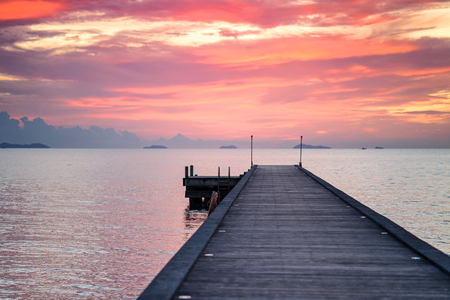 Wooden Pier with the orange sunset background, Golden sky, Red skyの写真素材