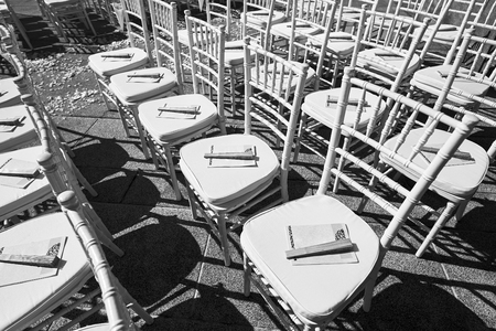 The black and white of chiavari wedding chairs setting for the ceremony with the cone of rose petals and Chinese fan as souvenir - Top viewの写真素材