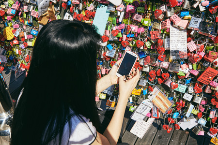 Seoul, South Korea - October 8, 2014: A girl take shot of the love key after locked in place at Namsan Towerのeditorial素材