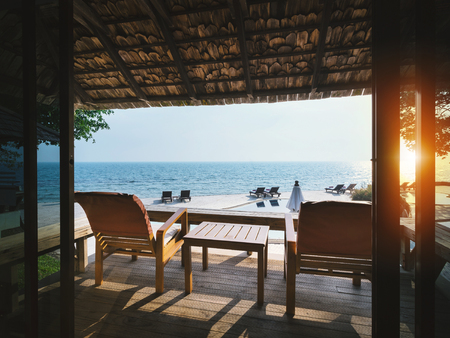 Two chairs at the terrace for relaxation with panoramic sea view during sunset on holiday summer vacationの写真素材