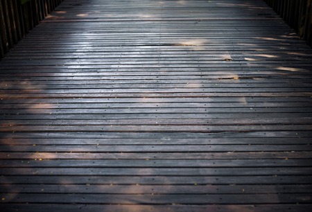 Selective focus of the old hard wood floor of the bridge with rough, dusty, grungy and cracked texture background.の写真素材