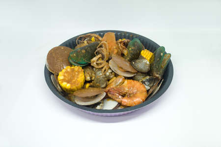 Seafood Menu on a Big Round Iron Plate Perspective View in White Backgroundの写真素材