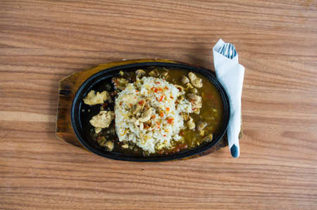 Chicken Rice Hotplate Top View on Wooden Table Horizontal Shootの写真素材